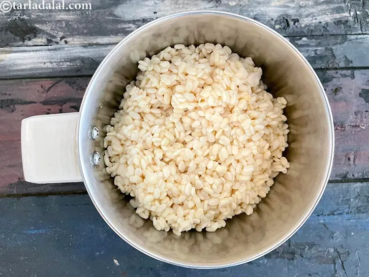 Step 8 – In a mixer, put&nbsp;<meta charset="UTF-8" />1/2 cup&nbsp;<a href="glossary-urad-dal-split-black-lentil-941i">urad dal (split black lentils)</a>&nbsp;, soaked for 2 …