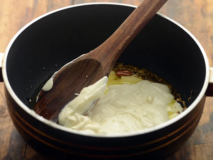 Step 17 – <div> Add the curds-besan mixture. If you are a beginner, remove pan from heat and …