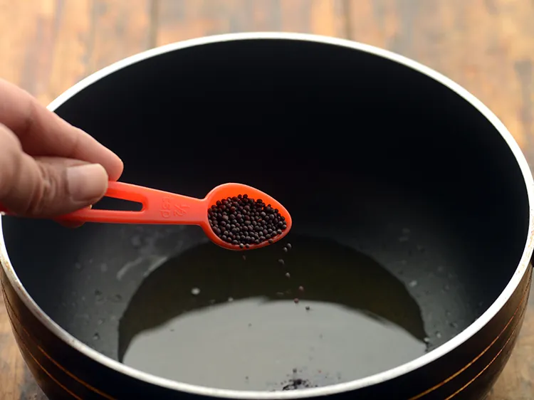 Step 9 – Once the ghee is hot, add mustard seeds.