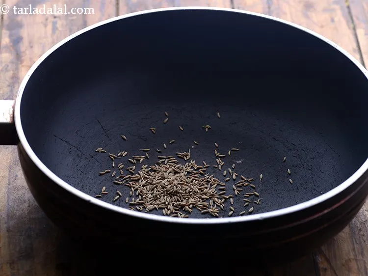 Step 14 – For tempering the <strong>dahiwali toovar dal</strong>, heat a deep non-stick pan on a medium flame. …