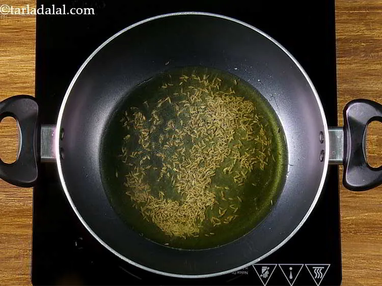Step 12 – Once the ghee is hot, add the cumin seeds.