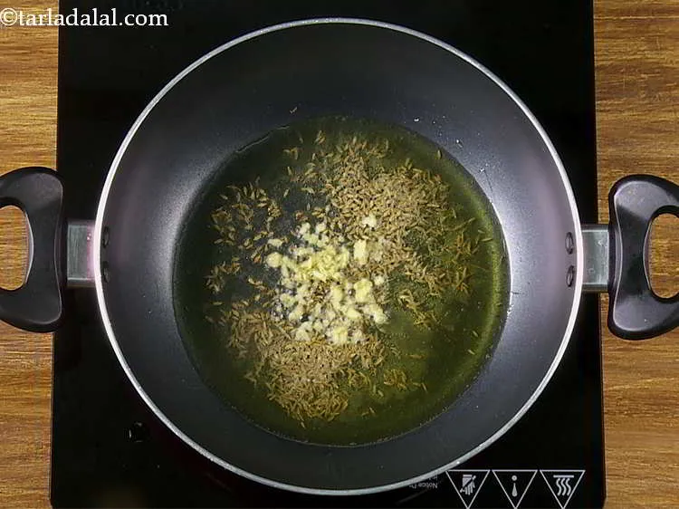 Step 13 – When the seeds crackle add the ginger.