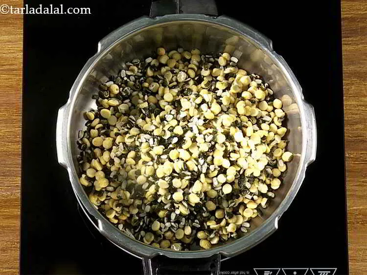 Step 6 – In a pressure cooker, add the soaked dals.