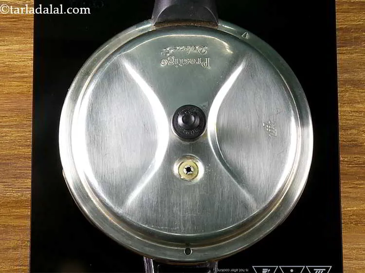 Step 9 – Mix well and pressure cook for 4 whistles or till the dals are cooked and …