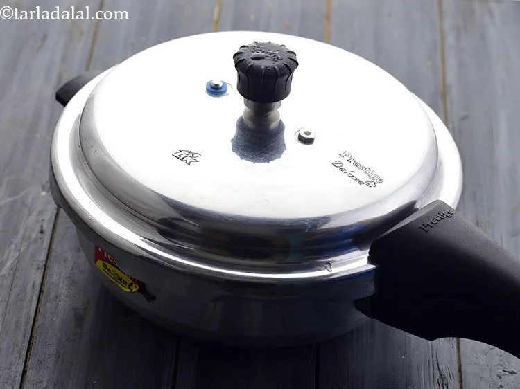 Step 26 – Pressure cook for 3 whistles. Then allow the pressure cooker to cool down slightly and …