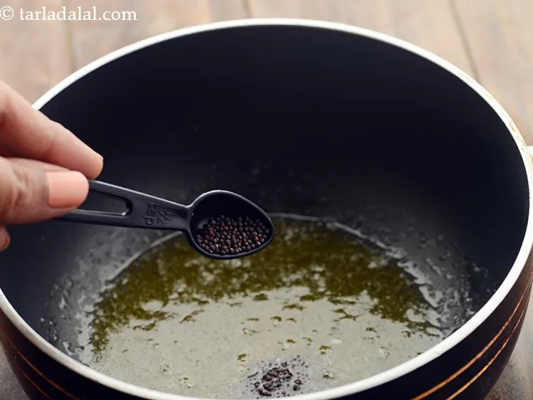 Step 13 – Once the ghee melts, add the mustard seeds.