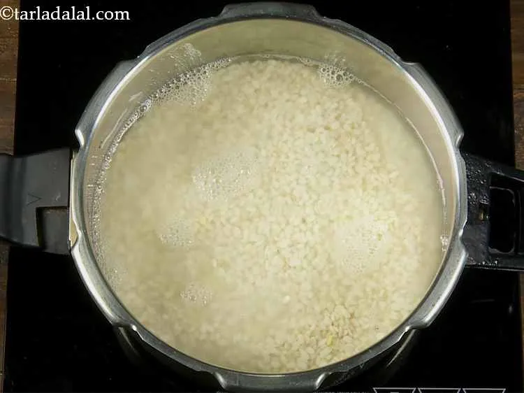 Step 3 – Add salt and 2 cups of water in the pressure cooker.