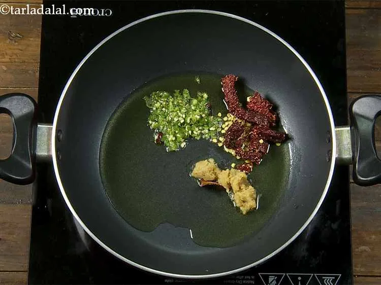 Step 11 – With this, add the broken dried red chillies and green chillies. The reasons for adding …