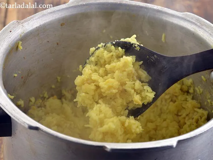 Step 12 – Pressure cook the dal and rice for 3 whistles. Allow the steam to escape naturally …