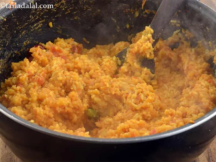Step 32 – Mix&nbsp;<strong>khichdi recipe | dal khichdi | toor dal khichdi </strong>&nbsp;well and cook on a medium …