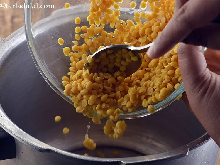 Step 6 – Take a pressure cooker and add the dal to it. We have used toor dal, …