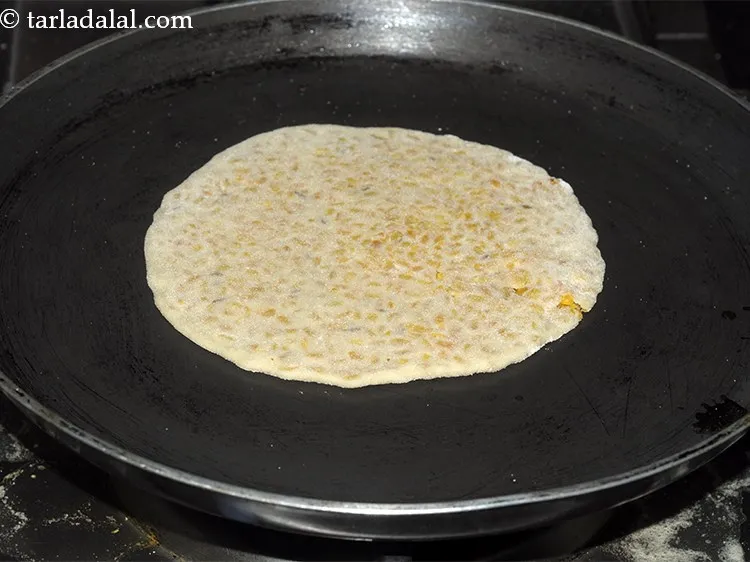 Step 25 – Heat a non stick tava/griddle and place the <strong>Dal Paratha</strong> gently.