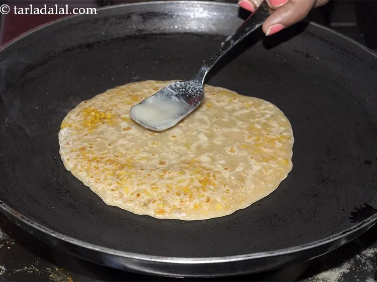 Step 26 – Allow to cook on side, add 1/2 tsp ghee and flip the <strong>Dal Paratha</strong>. Cook …