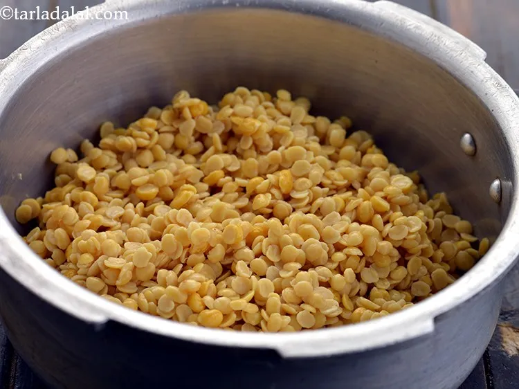 Step 14 – Add the soaked and drained dals in the pressure cooker.