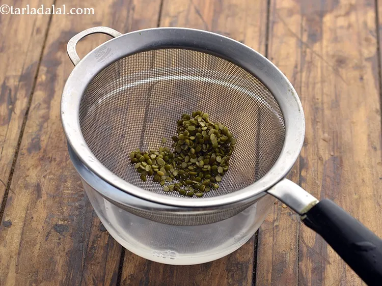 Step 9 – Drain the excess water using a strainer and discard it. Keep the washed moong dal …