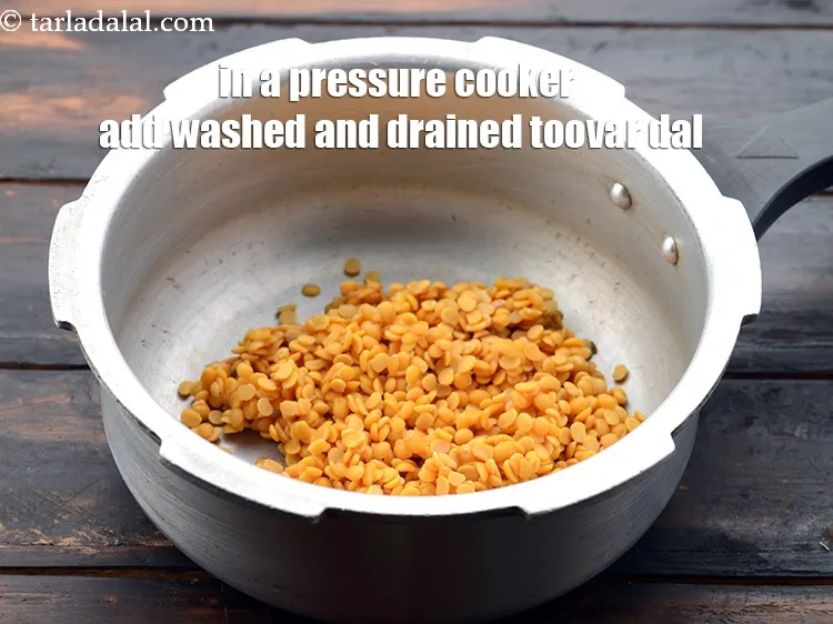 Step 4 – In a pressure cooker, take 1/2 cup&nbsp;<a href="https://www.tarladalal.com/glossary-toovar-dal-arhar-dal-toor-dal-split-pigeon-peas-tur-dal-955i">toovar (arhar) dal</a>, washed and drained.&nbsp;