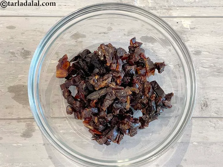 Step 3 – <meta charset="UTF-8" />In a deep bowl, put finely chopped seedless black dates.&nbsp;1 cup of&nbsp;<a href="https://www.tarladalal.com/recipes-using-dates-391">dates</a>&nbsp;(90 …