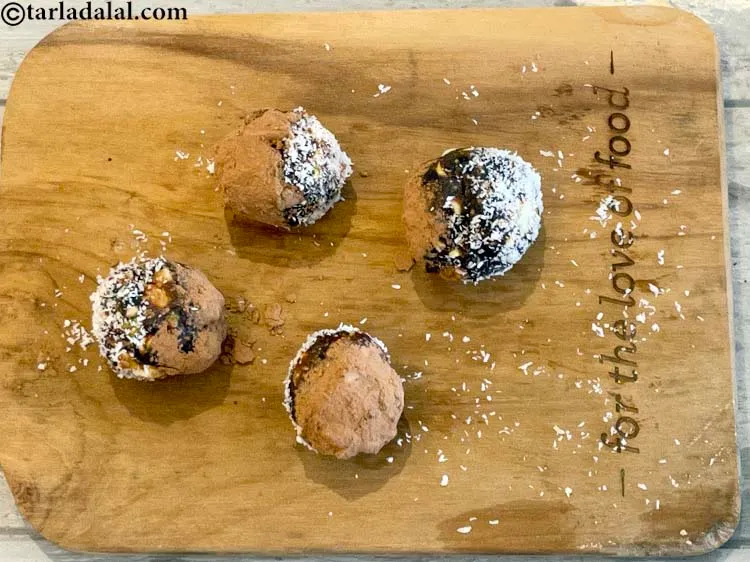 Step 10 – Take a ball and dip half side of each ball into the dessicated coconut and …