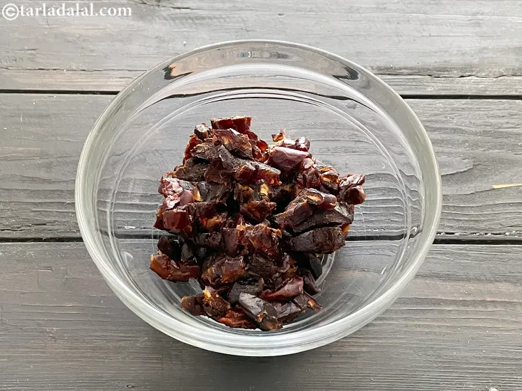 Step 3 – In a deep bowl, put finely chopped seedless black dates.&nbsp;1 cup of <a href="https://www.tarladalal.com/recipes-using-dates-391">dates</a> (90 …