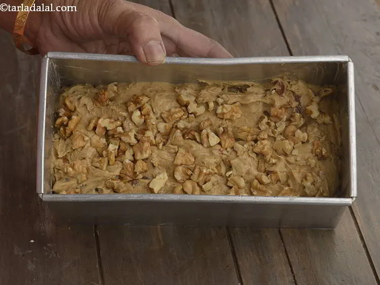 Step 24 – Sprinkle the remaining &frac14; cup of walnuts evenly over&nbsp;<strong>date walnut cake (eggless date walnut cake)</strong>. …