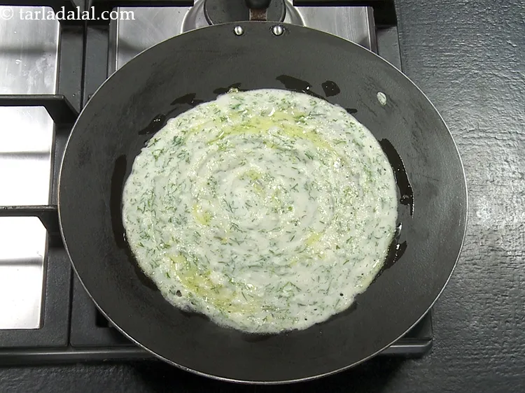 Step 27 – Smear &frac12; tsp of <a href="https://www.tarladalal.com/glossary-ghee-245i">ghee</a>&nbsp;evenly over it and along the edges.