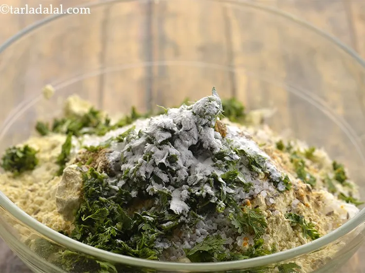 Step 13 – Add baking soda. It will help in making the lauki muthia soft.