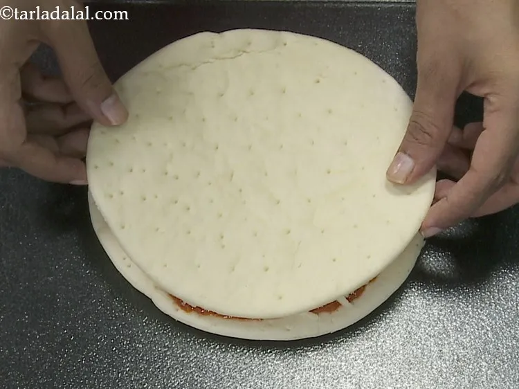 Step 16 – Place 1 more pizza base over it.