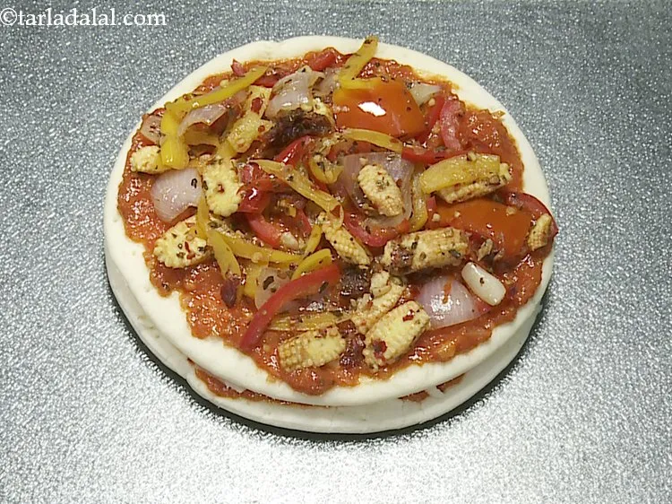 Step 18 – Also, sprinkle 1 portion of the crunchy vegetable topping evenly over it.