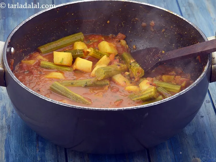 Step 25 – Add the drumstick-potato mixture along with its water and 2 tbsp&nbsp;finely&nbsp;<a href="https://www.tarladalal.com/glossary-chopped-coriander-783i">chopped coriander (dhania)</a>, mix …