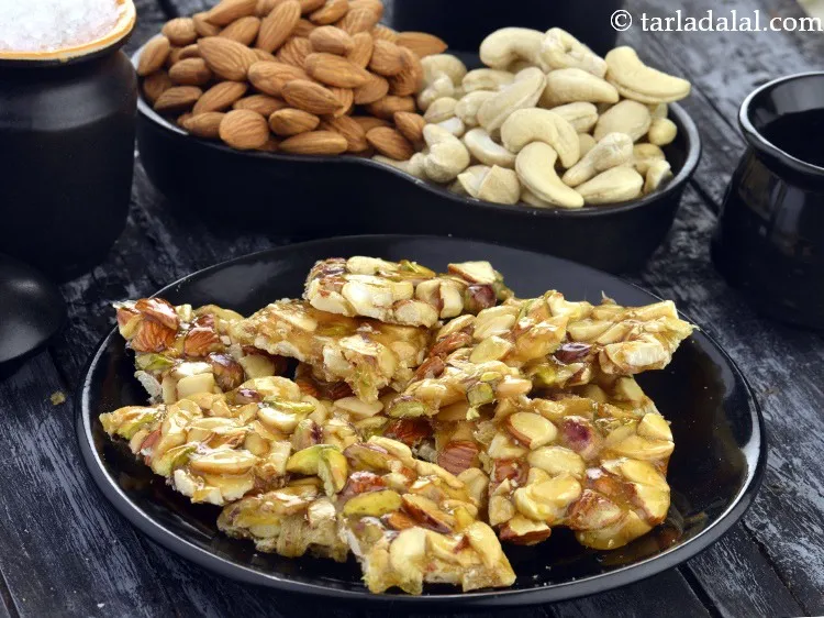 Step 23 – You can buy readymade mixed nut chikki or learn <a href="https://www.tarladalal.com/dry-fruit-chikki-cashew-almond-and-pistachio-chikki-40732r" target="_blank"><strong>how to make mixed …
