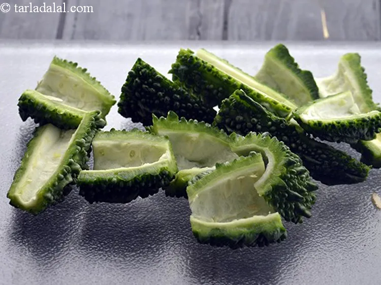 Step 4 – Scoop the bitter gourd halves using a spoon or your fingers.