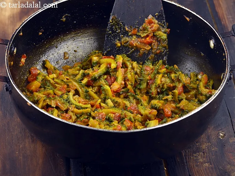 Step 24 – Add the cooked karela slices, mix gently and cook on a medium flame for 2 …