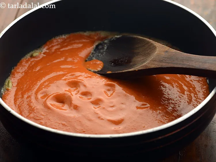 Step 20 – When the cardamom turns aromatic, carefully add the prepared gravy paste. &nbsp;