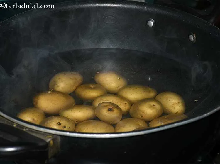 Step 3 – Take a vessel, fill it with water, put the baby potatoes into it and let …
