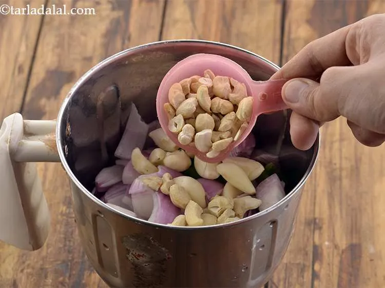 Step 20 – Now add the broken cashewnuts (kaju) into the mixture.