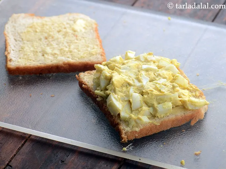 Step 9 – Place a portion of the egg mixture on one slice of bread.