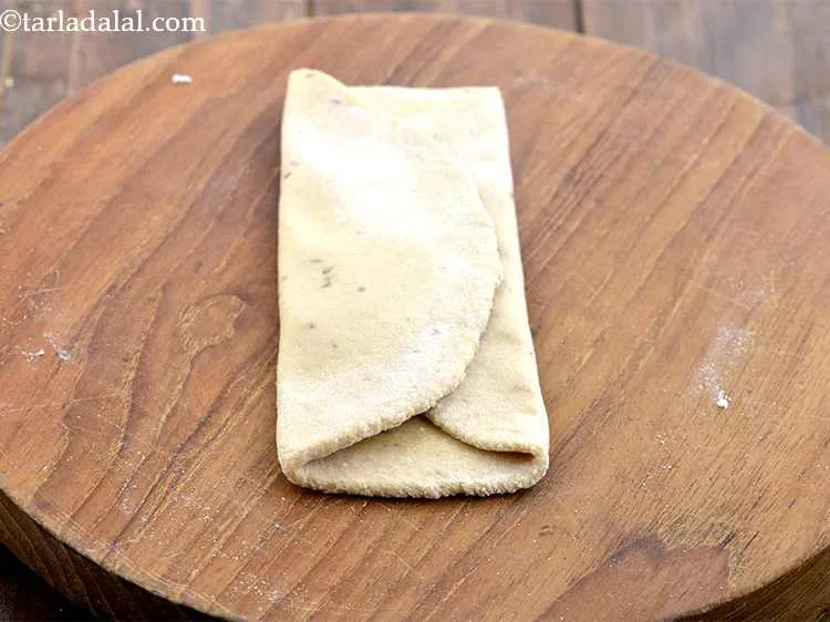 Step 11 – Fold the paratha over from one end to another end veritically. They should slightly overlap …