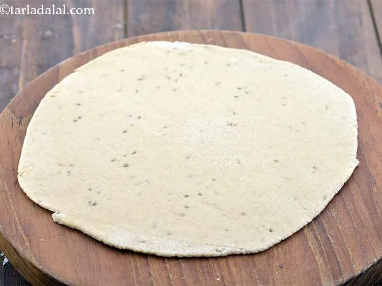 Step 13 – Dust the rolling surface with a little whole wheat flour and roll the paratha out …