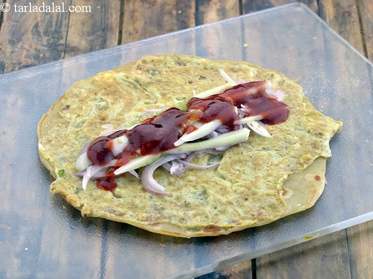 Step 31 – Also spread 1 tsp of&nbsp;<a href="https://www.tarladalal.com/glossary-red-chilli-sauce-lal-chilli-sauce-810i">chilli sauce</a> evenly over it.