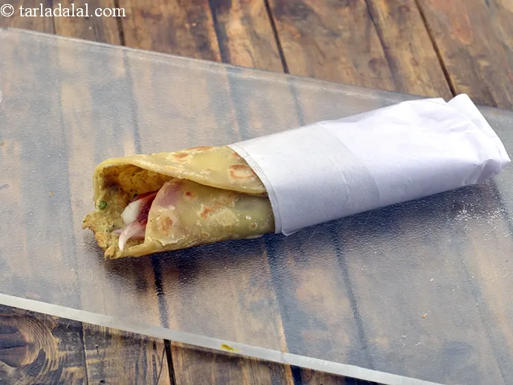 Step 33 – Place the egg roll over a rectangular shaped butter paper and wrap one side with …