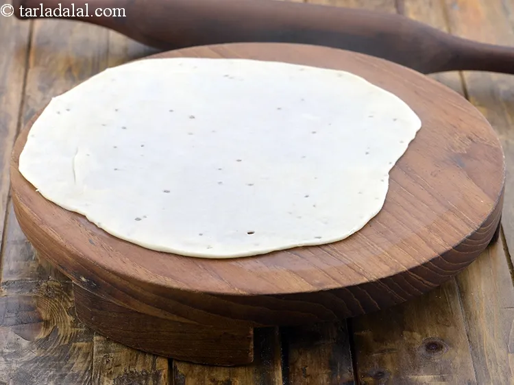 Step 16 – Roll a portion of the dough into a 175 mm. (7&rdquo;) diameter circle without using …