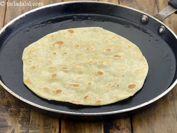 Step 18 – Place the rolled circle on it and cook using 1 tsp of oil till it …