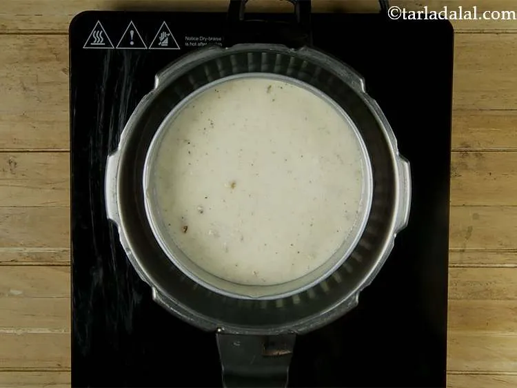 Step 15 – Slowly place the cake tin on the stand in the pressure cooker.