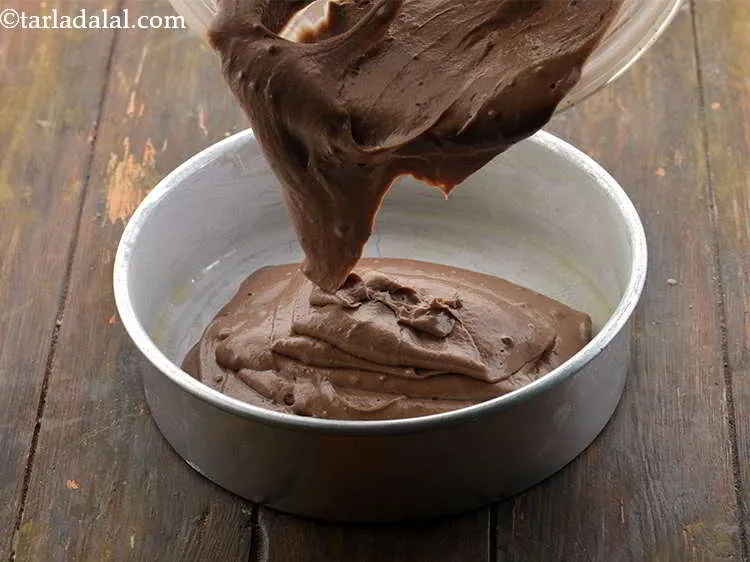 Step 47 – While the pressure cooker is being heated for e<strong>ggless chocolate cake in pressure cooker recipe …