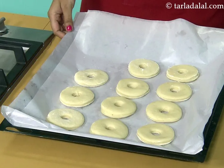 Step 55 – Leave enough space while covering the doughnuts with butter paper.