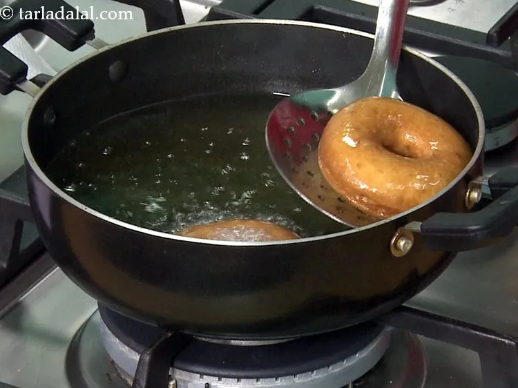 Step 31 – Deep fry the doughnuts on a slow flame, till they turn golden brown in colour …