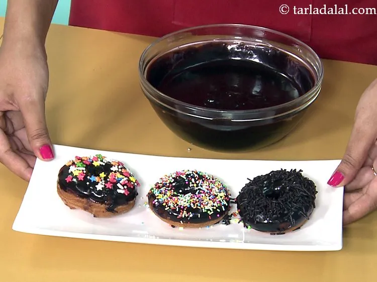 Step 46 – Decorate the<strong> chocolate doughnuts</strong> by sprinkling chocolate vermicelli / edible coloured vermicelli / edible coloured …