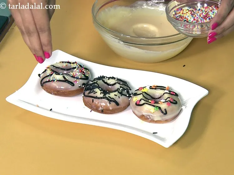 Step 51 – Decorate the <strong>chocolate donuts </strong>by sprinkling chocolate vermicelli / edible coloured vermicelli / edible coloured …