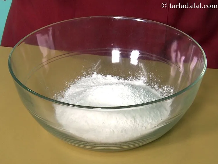 Step 11 – To make <strong>donuts</strong>, add the plain flour in a deep bowl and mix well. Here …