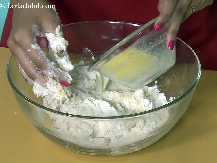 Step 16 – Add the milk-butter mixture gradually to make a dough for <strong>chocolate donuts</strong>. Mix the mixture …